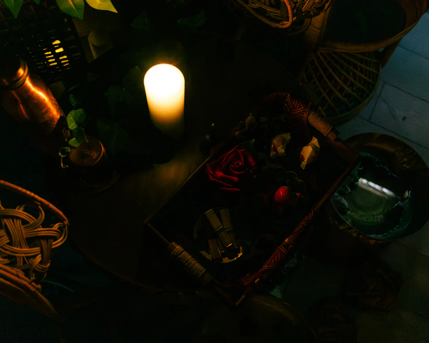Candlelit welcome tray with flowers, fruit and refreshments