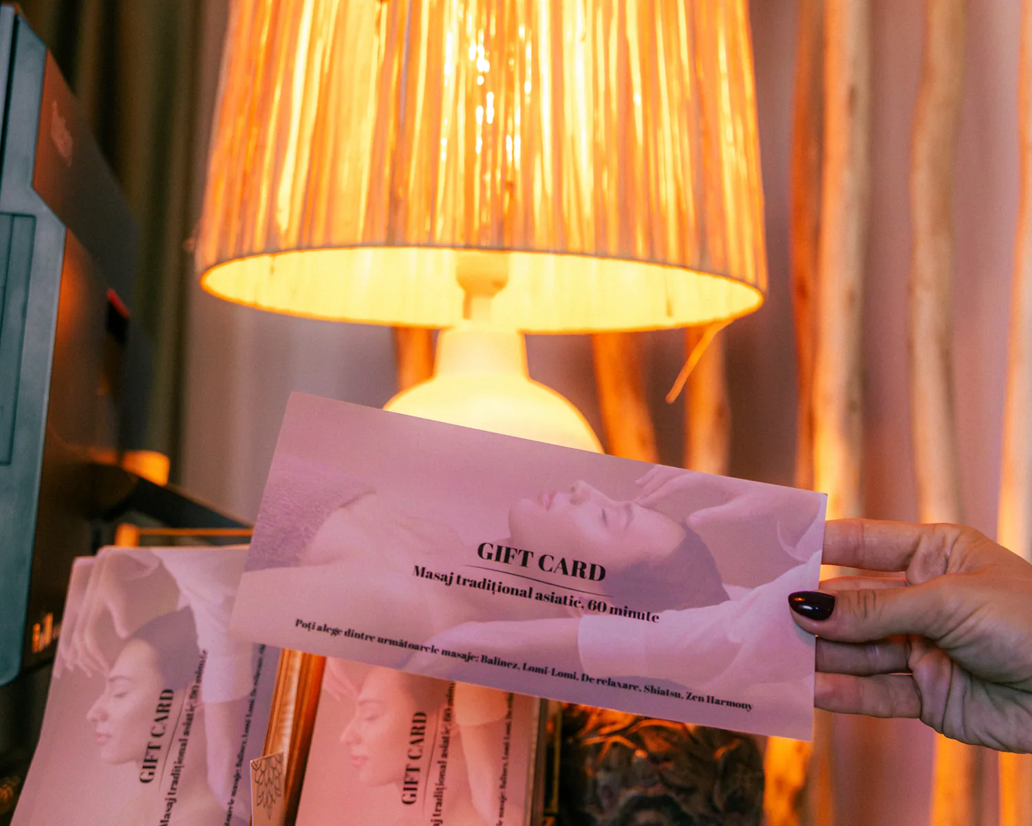 Close view of Luxury Spa gift vouchers beside a table lamp