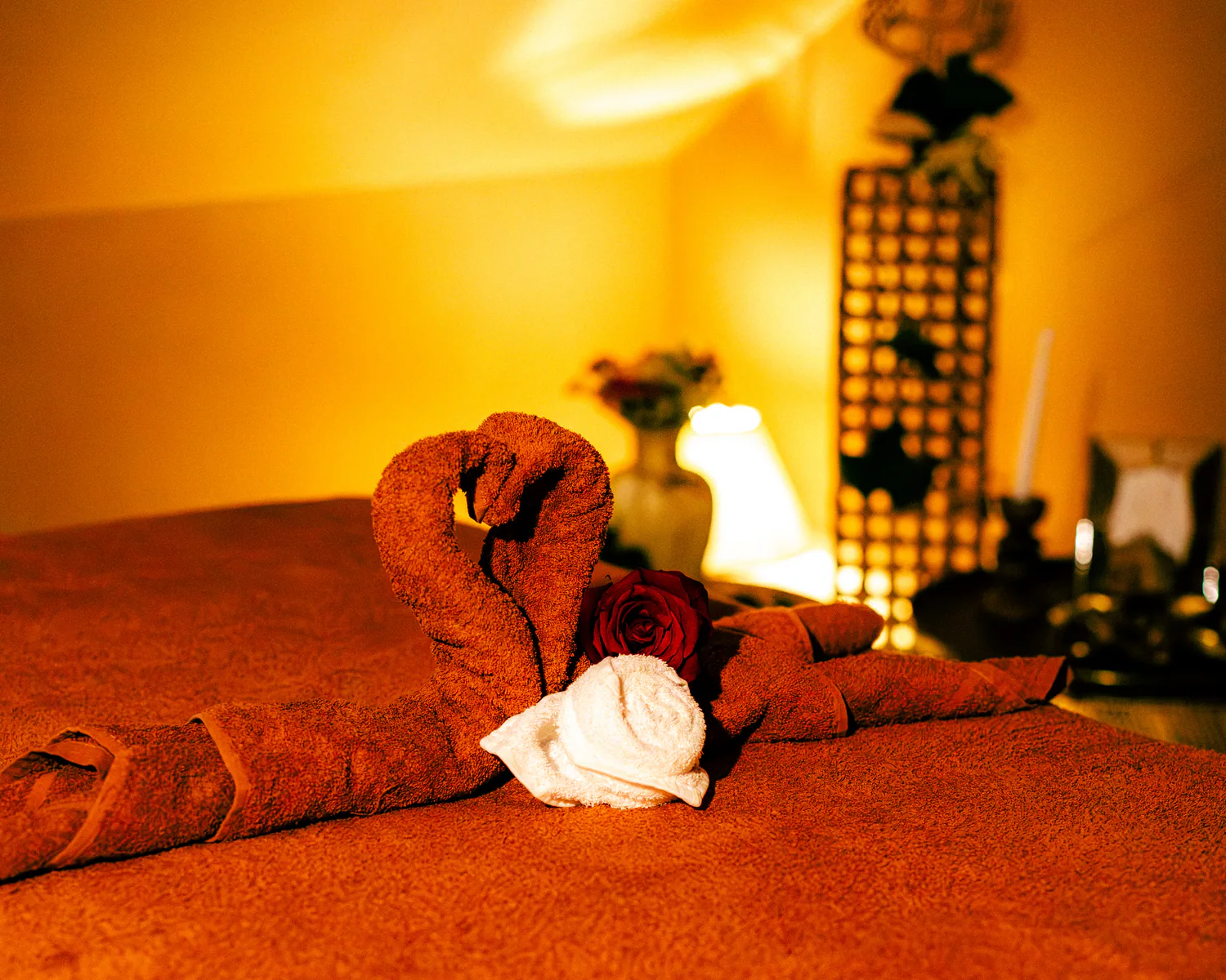 Spa treatment bed prepared with folded towels