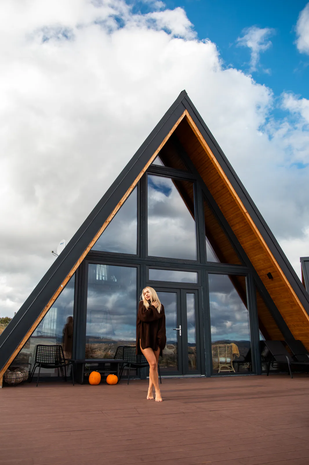 A-frame cabin with a woman standing at the entrance