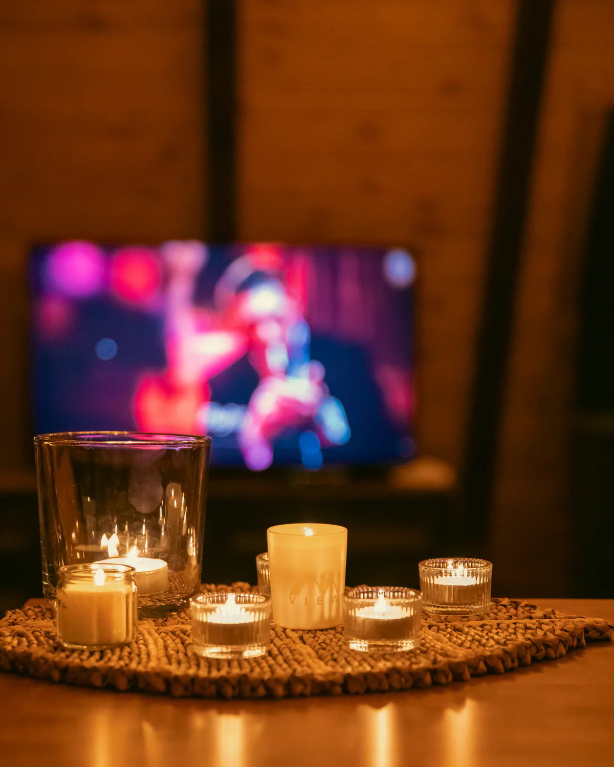 Candlelit table inside the cabin with a television in the background