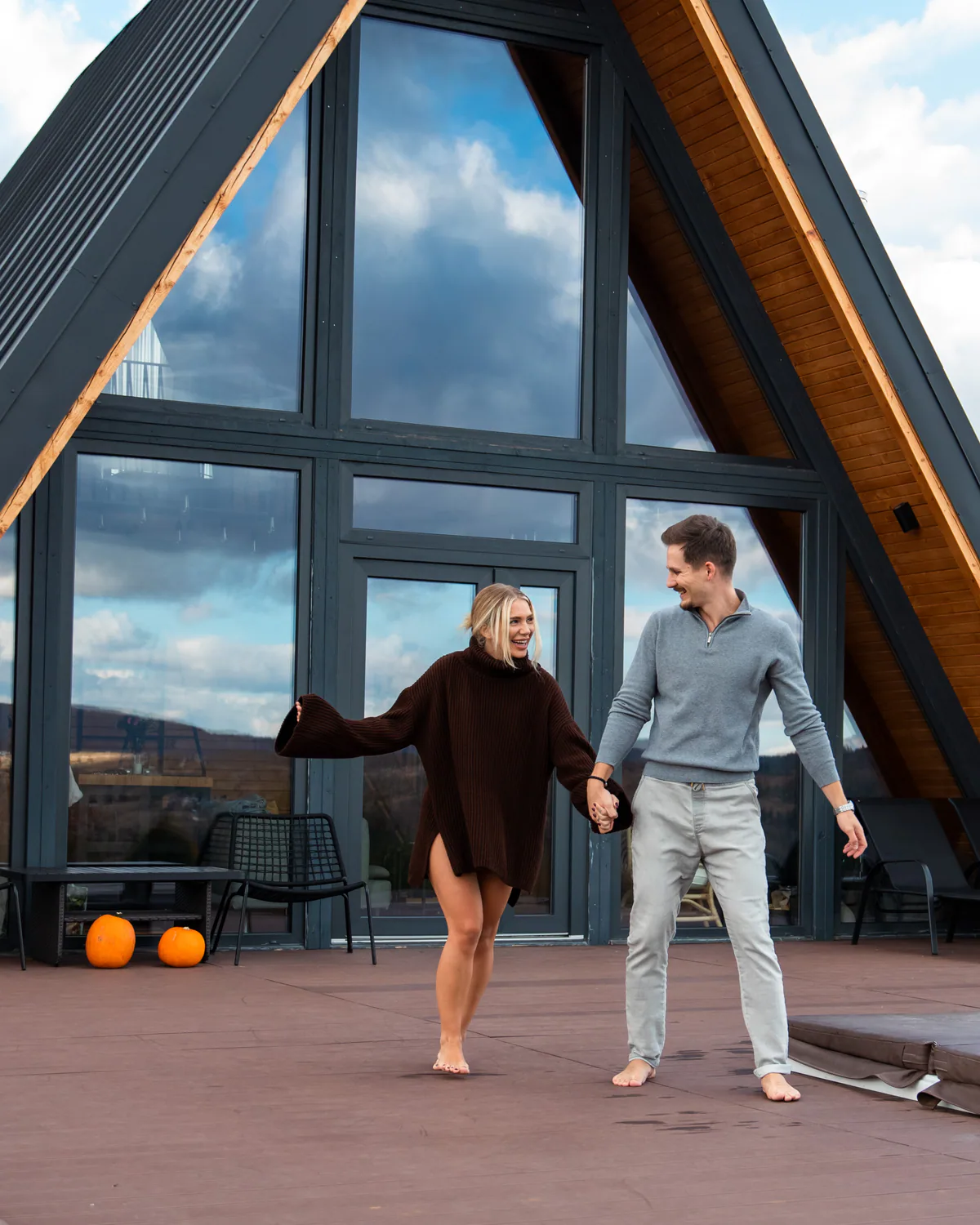 Couple walking together outside the mountain cabin