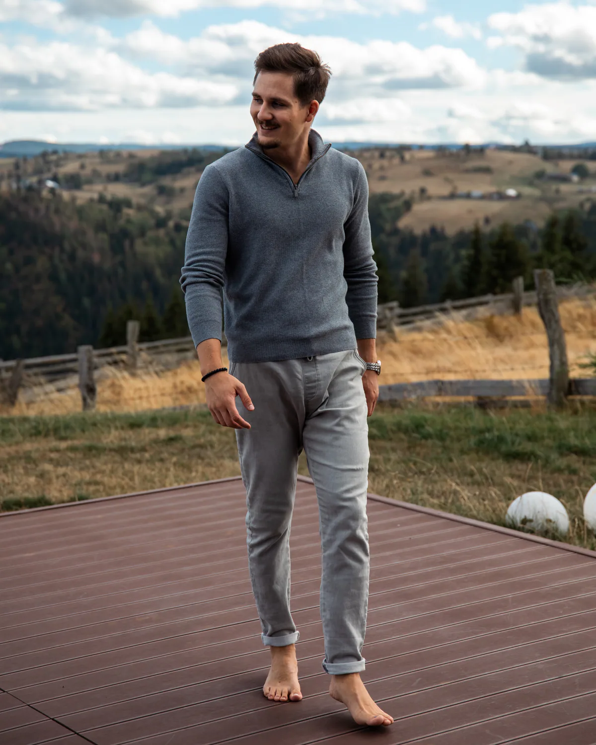 Man walking barefoot on the cabin terrace