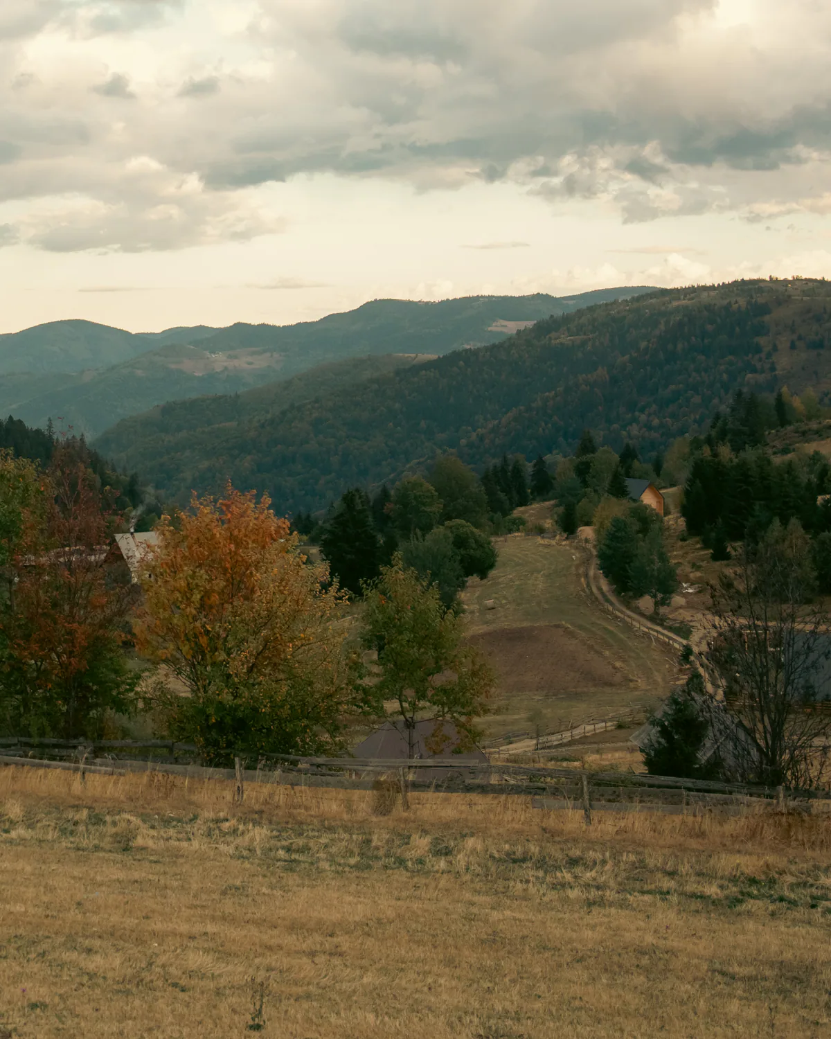 Mountain valley and hillside homes beneath a cloudy sky