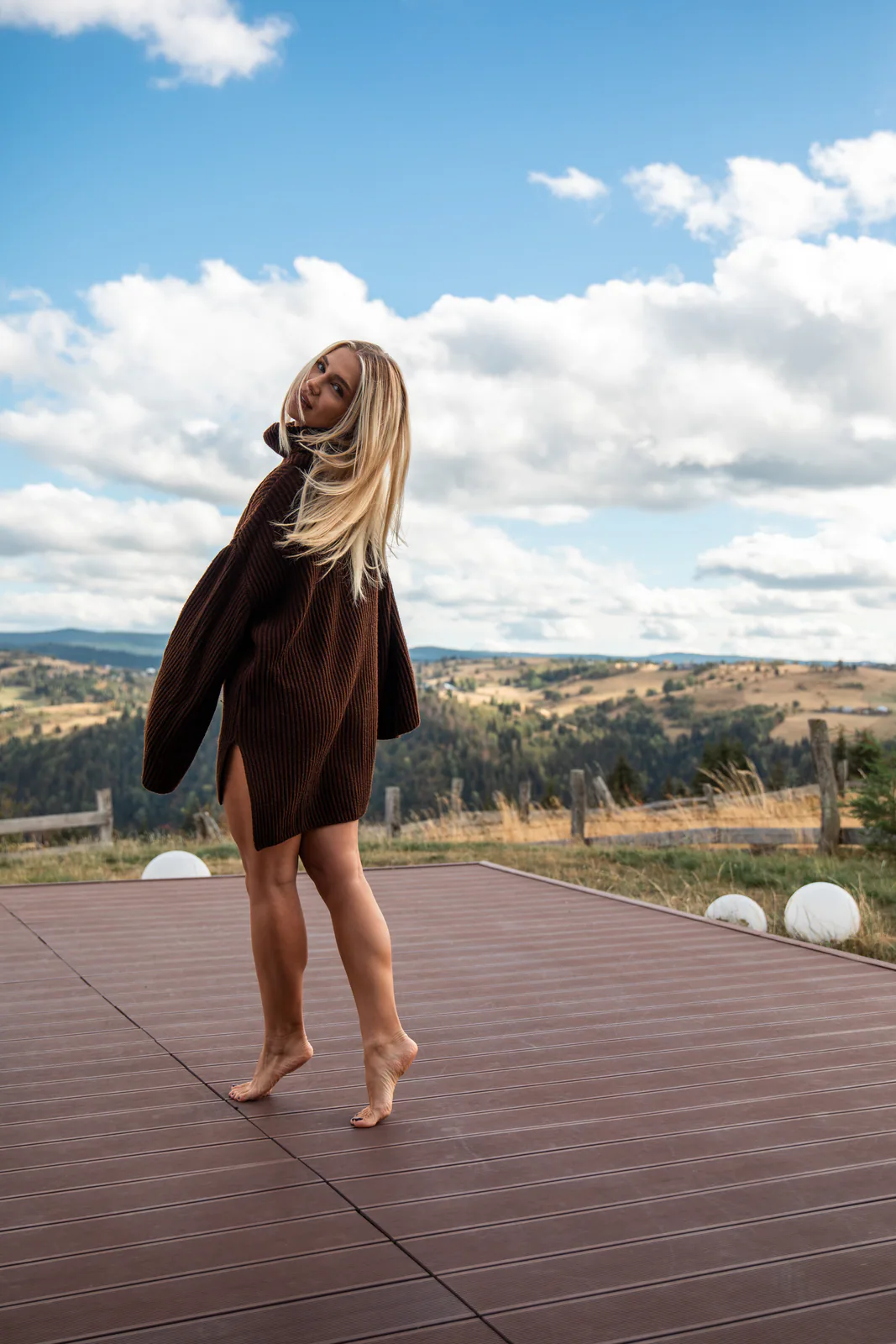Woman looking across the mountains from the cabin terrace