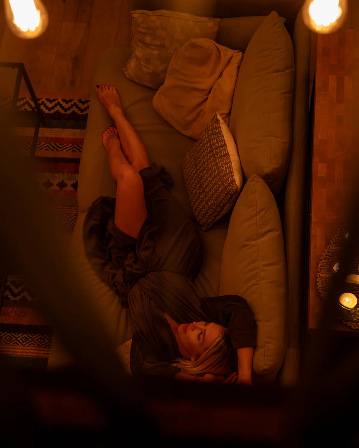Overhead view of a woman resting on the cabin sofa
