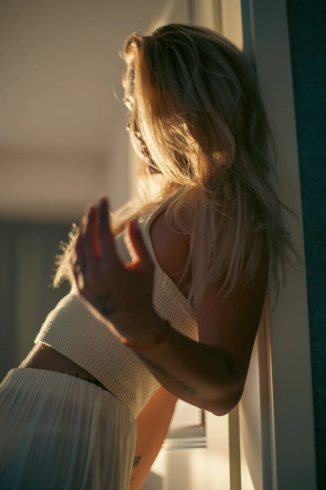 Woman illuminated by warm doorway light
