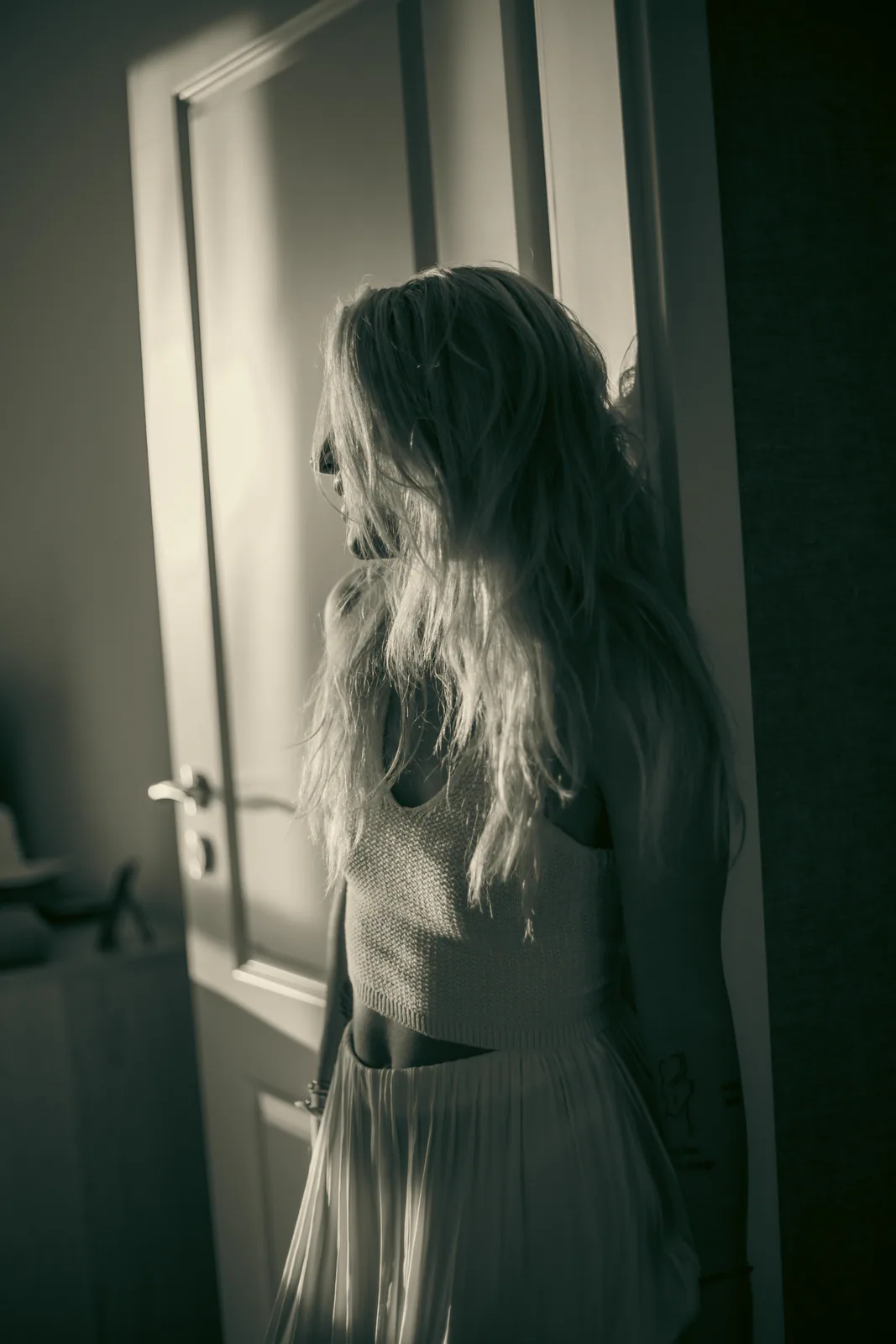 Black-and-white portrait beside a doorway