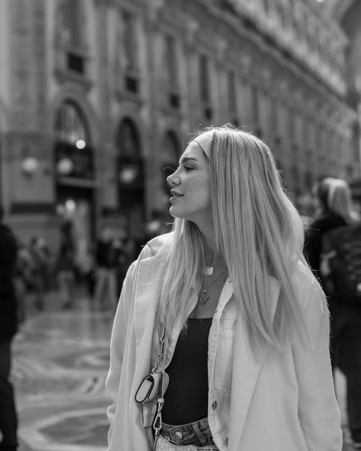 Black-and-white profile portrait in a city plaza