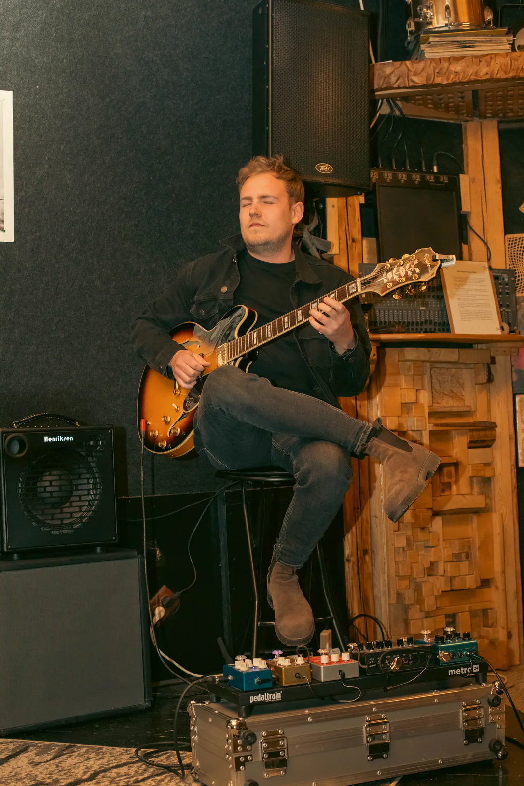 Seated musician holding an instrument