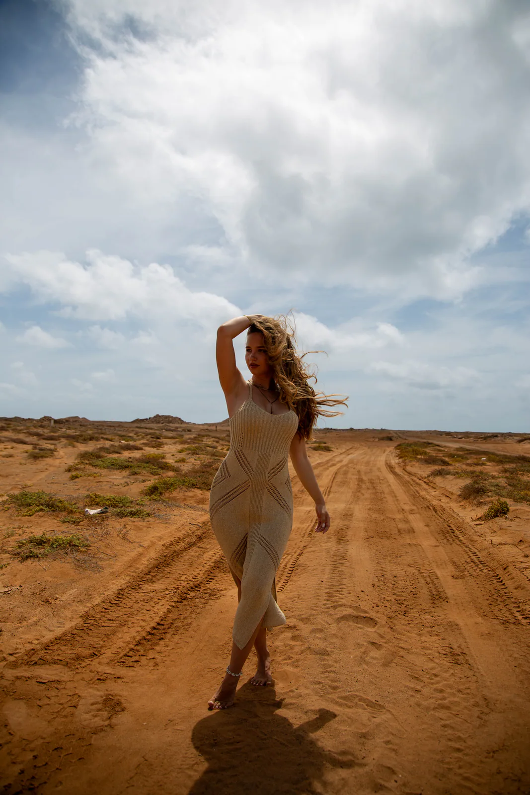 Person standing in a sandy landscape