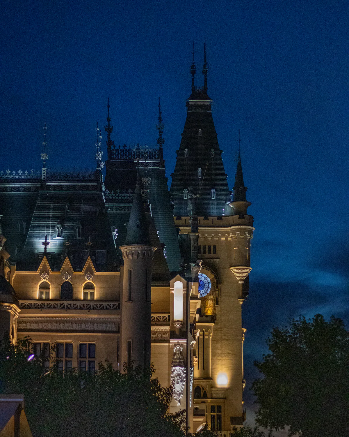 Illuminated castle beneath a deep blue evening sky