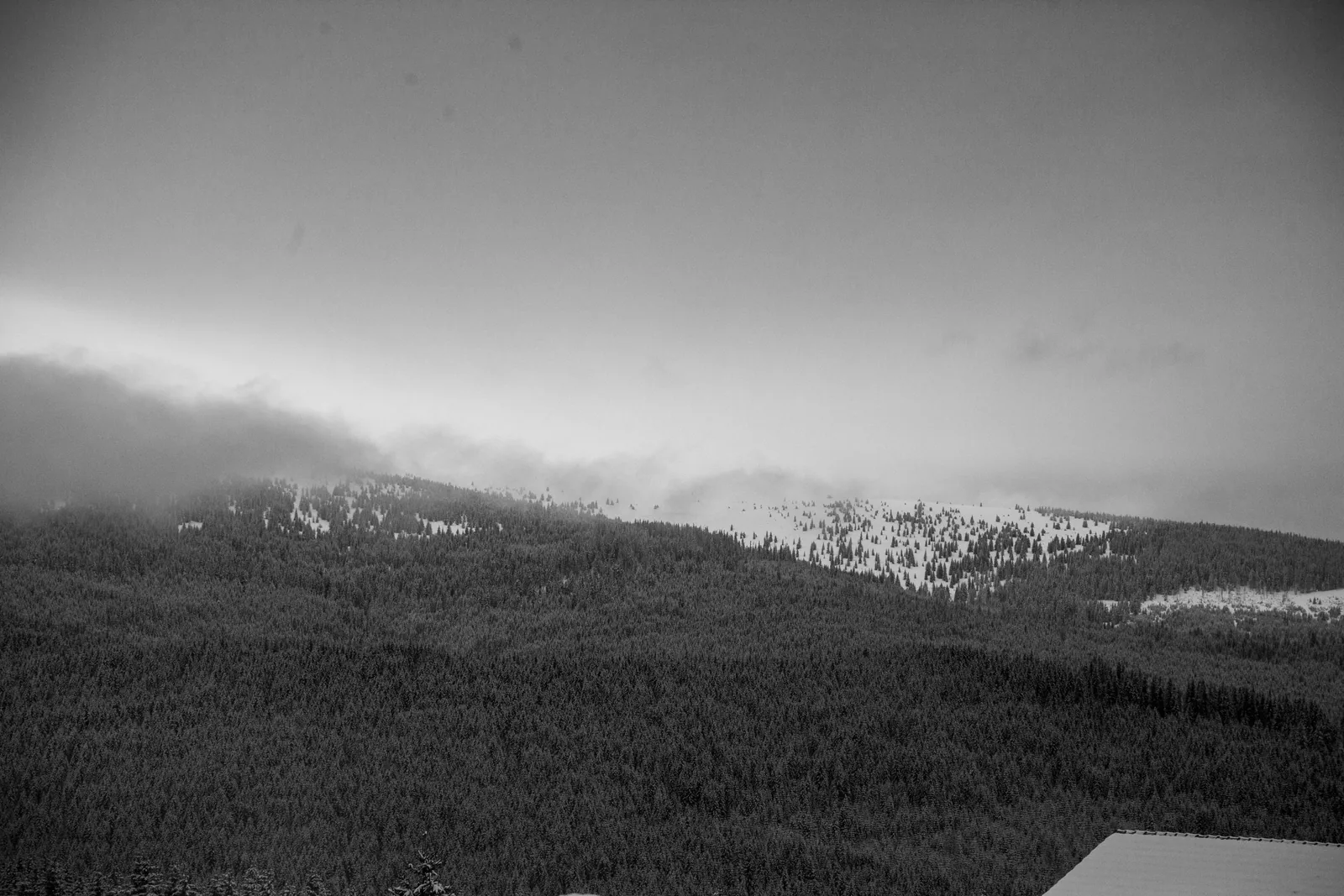 Mist drifting across layered hills